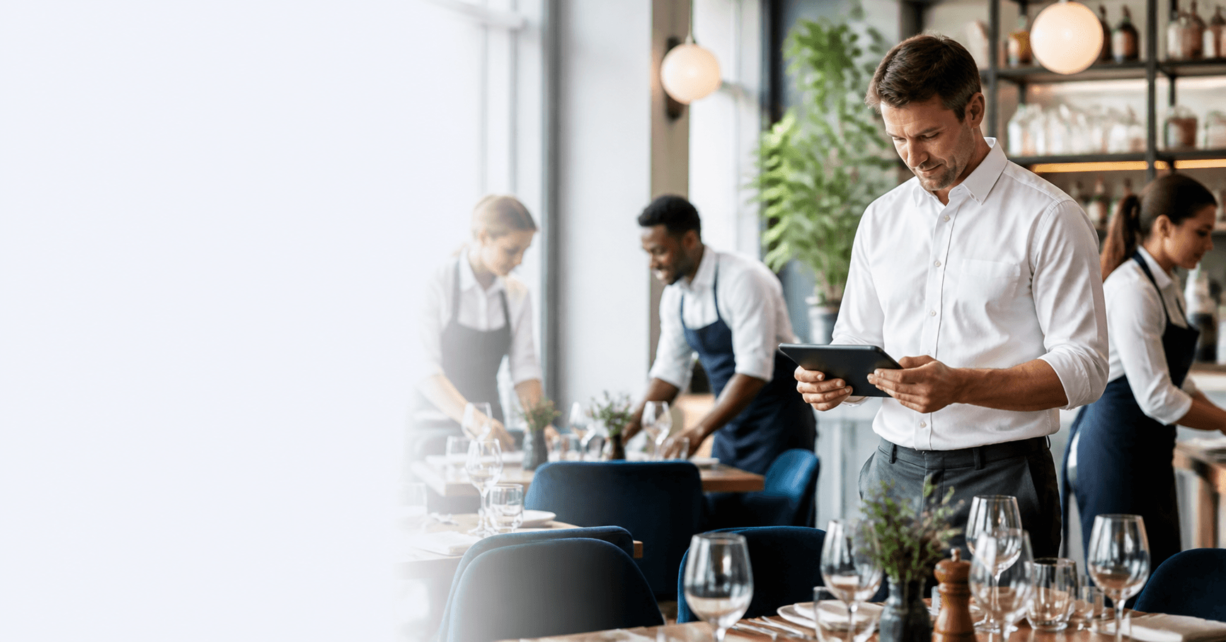 Restaurant manager and front-of-house team preparing for service